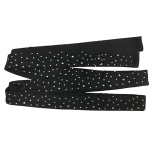 Macro detail of elastic black mesh strap with sparkling silver rhinestones for DIY dresses