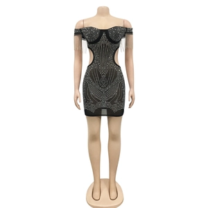 Detailed close-up of rhinestone fringe and side cutout on black mesh party dress