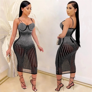 Detail view of black bodycon midi dress featuring vertical rhinestone stripes and thin straps