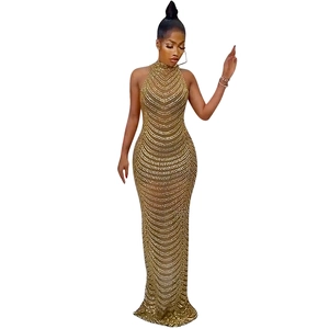 Detail of gold sleeveless evening gown featuring intricate sequin patterns and mermaid hem