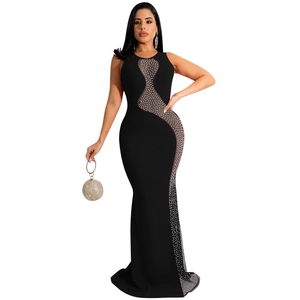 Detailed view of sheer mesh patchwork with white pearls and rhinestones on black dress