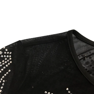 Close-up of black mesh fabric with sparkling silver rhinestones on the shoulder detail