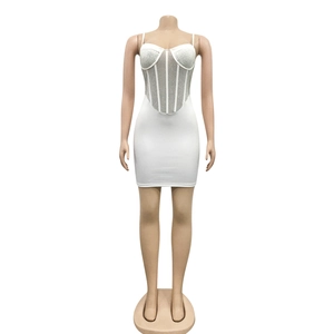 Detail of white bodycon mini dress featuring mesh rhinestones and corset boning structure