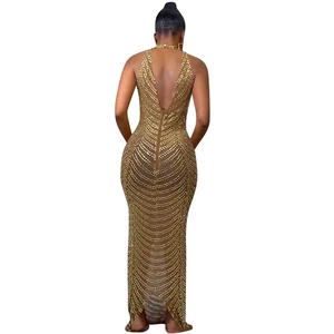 Detail of a backless gold sequined evening gown with intricate beaded patterns