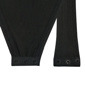 Detail of the high-elastic black bodysuit showing three-snap closure at the bottom hem