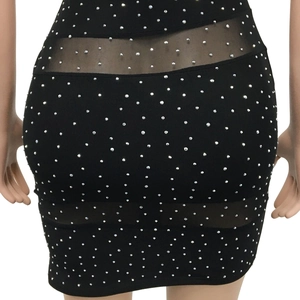 Detail of sheer mesh patchwork with silver rhinestones on a sexy black mini dress