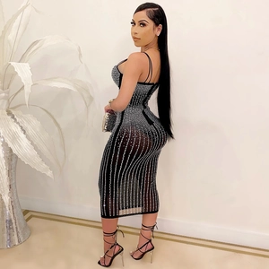Detail of black mesh bodycon dress featuring vertical silver rhinestone stripes and straps