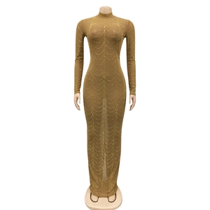 Detailed close-up of brown mesh dress with sparkling golden rhinestone wave patterns