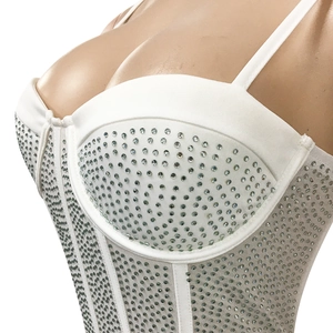 Detail of white corset dress featuring silver rhinestones and delicate spaghetti straps