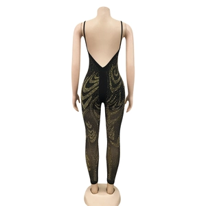 Detail of black backless jumpsuit with gold rhinestones and elegant mesh perspective