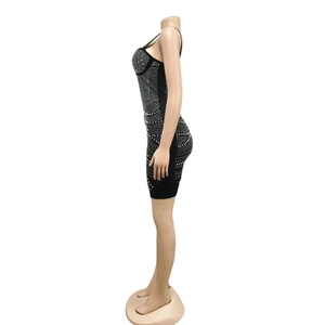 Close-up side view of sexy black bodycon dress with rhinestone patterns and spaghetti straps