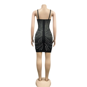 Back view of a sexy black mini dress featuring symmetrical rhinestone and pearl patterns
