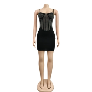 Detail of black corset mini dress featuring vertical silver rhinestone stripes and thin straps