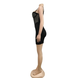 Close-up of black bodycon mini dress with sparkling rhinestones and thin straps