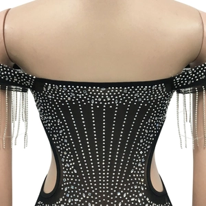 Detail of black mesh dress featuring silver rhinestones and sparkling fringe chains