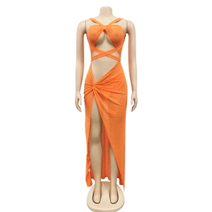Close-up of bright orange sequined mesh fabric with cutout waist and high slit details