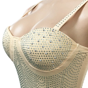 Detail of nude corset top with shimmering silver rhinestones and adjustable straps