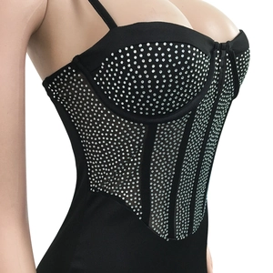 Detailed close-up of a black mesh corset top with silver rhinestones and thin straps