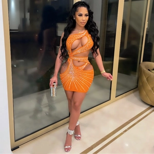 Detail of sexy orange bodycon dress with rhinestone patterns and cutout design