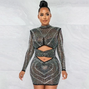 Detail of sheer mesh dress featuring heart-shaped rhinestones and side cut-outs