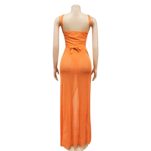 Detail view of orange mesh dress back with sparkling rhinestones and waist ribbon bow