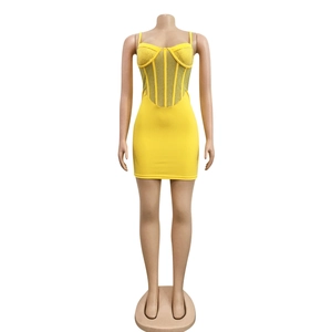 Detail view of yellow mesh corset dress with sparkling rhinestone embellishments