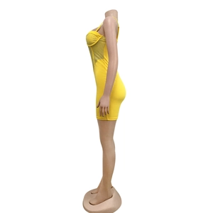 Detail of yellow bodycon mini dress with rhinestone accents and spaghetti straps