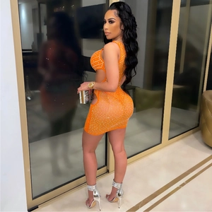Detail of sexy orange rhinestone mini dress featuring a side cutout for party wear
