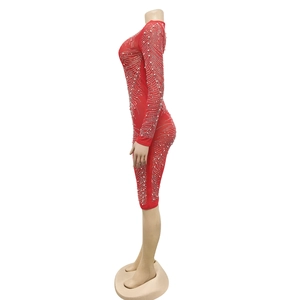 Close-up of red bodycon dress featuring intricate wave-patterned rhinestone details