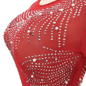 Close-up of red mesh dress with luxury silver rhinestones and white pearls detailing