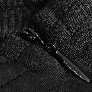 Detail of a concealed teardrop zipper on the black textured fabric of the dress