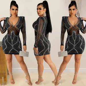 Detail view of black rhinestone mini dress with mesh inserts and padded shoulders