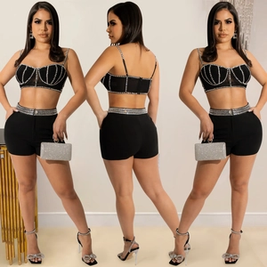 Detail showing the rhinestone trim on black camisole top and matching shorts set