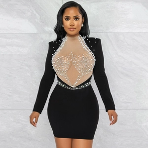 Detail of black mini dress with mesh insert featuring hand-sewn pearls and rhinestones