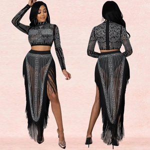 Detail of sheer mesh dress with silver rhinestones and high slit fringe hemline