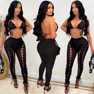 Close-up of sexy black mesh two-piece set with side criss-cross lacing and metal eyelet detail