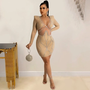 Close-up of sparkling silver rhinestones on a mesh mini dress with cutout neck