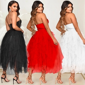 Three models wearing strapless mesh tulle dresses in black, red, and white colors