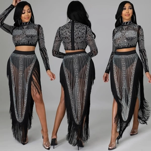 Detailed view of women's black rhinestone two-piece set with long sleeves and fringe skirt