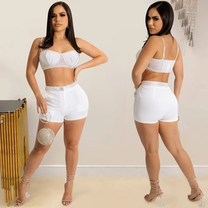 Detail of white two-piece set with rhinestones on camisole top and matching shorts