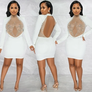Detail of white mini dress with mesh patchwork, pearls, rhinestones and backless design