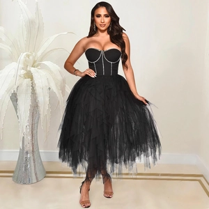 Detail of black strapless corset dress with silver rhinestone trim and layered mesh skirt