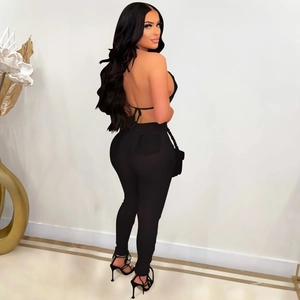 Detail of sexy black halter backless top and leggings set with tie-back design