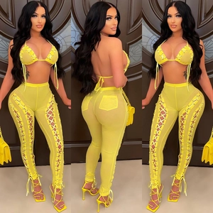 Detail view of yellow mesh two-piece set featuring lace-up bikini top and sheer trousers