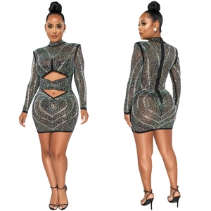 Detailed close-up of a black sheer mesh dress with rhinestones and waist cut-outs
