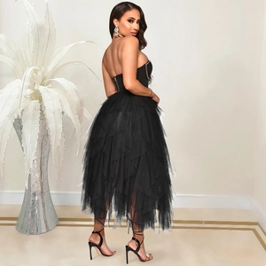 Detail of the layered black tulle cake skirt and side zipper on a strapless dress