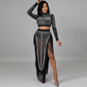 Detail of sheer black two-piece set featuring shimmering rhinestones and long fringe hem
