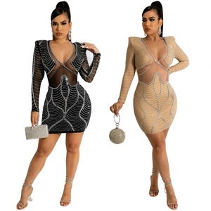 Detail of sheer mesh dress with rhinestones, long sleeves and V-neck in black and champagne