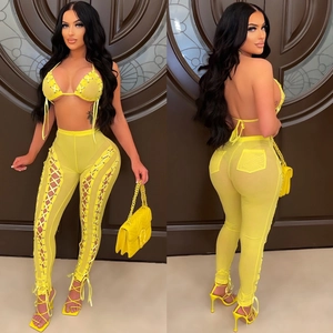 Bright yellow mesh two-piece set featuring halter bikini top and side cutout lace-up pants
