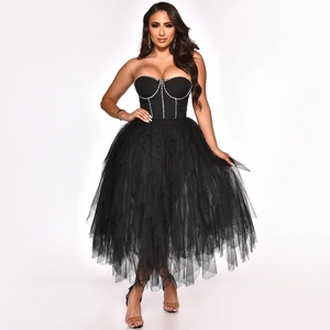 Close-up of sparkling rhinestone corset detailing on black mesh strapless dress